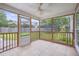 Relaxing screened porch featuring tile flooring and open views of the backyard's green space at 5289 Mulholland Dr, Summerville, SC 29485