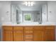 Bathroom double vanity featuring a large mirror and wood cabinets, offering both style and storage at 5289 Mulholland Dr, Summerville, SC 29485