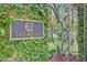 Close up of a 62 Eastlake Road sign on an ornate iron gate with lush greenery at 62 Eastlake Rd, Mount Pleasant, SC 29464