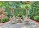 Secluded backyard retreat with a stone patio, water feature, and lush greenery at 62 Eastlake Rd, Mount Pleasant, SC 29464