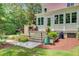 Scenic view of the backyard with outdoor kitchen and landscaped steps leading to the main house at 62 Eastlake Rd, Mount Pleasant, SC 29464