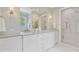 Elegant bathroom with double sinks, white cabinetry, marble countertops, and a glass-enclosed shower at 62 Eastlake Rd, Mount Pleasant, SC 29464
