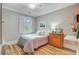 Cozy bedroom featuring a wood floor, window with shutters, and natural light at 62 Eastlake Rd, Mount Pleasant, SC 29464