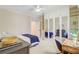 Well-lit bedroom featuring a built-in wardrobe with mirrored doors and desk area at 62 Eastlake Rd, Mount Pleasant, SC 29464