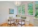 Charming breakfast nook features a built-in bench, round table, and natural light from surrounding windows at 62 Eastlake Rd, Mount Pleasant, SC 29464