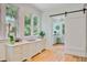 Bright butler's pantry with ample storage, marble counters, and views of the beautiful landscape at 62 Eastlake Rd, Mount Pleasant, SC 29464
