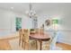 Bright dining room with hardwood floors features an oval wooden table under a decorative chandelier at 62 Eastlake Rd, Mount Pleasant, SC 29464