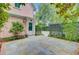 Side entrance to pink home with a stone patio, potted plants, and lattice fencing at 62 Eastlake Rd, Mount Pleasant, SC 29464