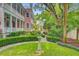 Two-story pink home with manicured backyard gardens and mature landscaping at 62 Eastlake Rd, Mount Pleasant, SC 29464