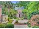 Exterior view of a charming house with a landscaped yard, palm trees, and unique architectural details at 62 Eastlake Rd, Mount Pleasant, SC 29464