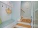 Comfortable foyer with a bench and storage, leading to hardwood stairs at 62 Eastlake Rd, Mount Pleasant, SC 29464