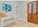 Welcoming foyer with a decorative table, artwork, and a wooden front door with glass panels at 62 Eastlake Rd, Mount Pleasant, SC 29464