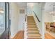 Foyer featuring wood floors, carpeted stairs, and an arched doorway to the dining room at 62 Eastlake Rd, Mount Pleasant, SC 29464