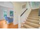 Foyer with wood floors, carpeted staircase, and an archway leading to the living room at 62 Eastlake Rd, Mount Pleasant, SC 29464