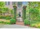 Ornate iron gate with brick columns covered in vines leading to the front of the house at 62 Eastlake Rd, Mount Pleasant, SC 29464