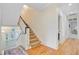 Bright hallway leading to a staircase with carpeted steps and white railing at 62 Eastlake Rd, Mount Pleasant, SC 29464