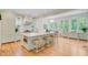 Modern kitchen with a large island, hardwood floors, and stainless steel appliances at 62 Eastlake Rd, Mount Pleasant, SC 29464