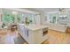 Beautiful kitchen with hardwood floors features a large island with a sink and an adjacent living room at 62 Eastlake Rd, Mount Pleasant, SC 29464