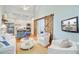 Open-concept living room flows into kitchen, featuring hardwood floors and barn door at 62 Eastlake Rd, Mount Pleasant, SC 29464