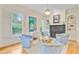 Inviting living room with light blue chairs, fireplace, wood floors, and built in shelving at 62 Eastlake Rd, Mount Pleasant, SC 29464