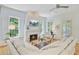 Cozy living room with fireplace, hardwood floors and large windows bringing in natural light at 62 Eastlake Rd, Mount Pleasant, SC 29464