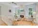 Comfortable living room with white painted brick fireplace, modern ceiling fan, and hardwood flooring at 62 Eastlake Rd, Mount Pleasant, SC 29464
