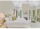 Serene main bedroom boasts a fireplace, vaulted ceiling, and ample natural light from large windows at 62 Eastlake Rd, Mount Pleasant, SC 29464