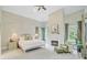 Cozy main bedroom features a fireplace, sitting area, and large windows with beautiful views at 62 Eastlake Rd, Mount Pleasant, SC 29464