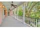 Spacious porch with white pillars, ceiling fans, and views of the lush landscape at 62 Eastlake Rd, Mount Pleasant, SC 29464