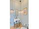 Stylish powder room featuring vintage-inspired fixtures, a unique mirror, and elegant wall color at 62 Eastlake Rd, Mount Pleasant, SC 29464