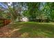 A spacious backyard with grass and mature trees, providing ample space for outdoor activities at 638 Cashew St, Charleston, SC 29407