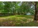 A large green backyard with privacy fencing and mature trees, creating a serene setting at 638 Cashew St, Charleston, SC 29407