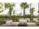 Inviting outdoor space with benches and fire pit, surrounded by palm trees, offering a relaxing atmosphere at 722 Meadowbrook Ln, Summerville, SC 29486