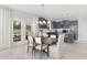 Light-filled dining area with modern light fixture, open to kitchen, and offering outdoor access at 724 Meadowbrook Ln, Summerville, SC 29486