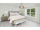 Relaxing main bedroom featuring a sitting bench, natural light, and minimalist decor at 724 Meadowbrook Ln, Summerville, SC 29486