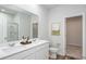 Bright bathroom with double sinks, white cabinetry, and a large mirror, offering plenty of counter space at 778 Meadowbrook Ln, Summerville, SC 29486