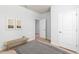 Bright bedroom featuring neutral decor, wood bench, and an open doorway at 778 Meadowbrook Ln, Summerville, SC 29486