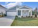 Charming home with gray siding, white trim, inviting front porch, and a well-maintained front lawn at 778 Meadowbrook Ln, Summerville, SC 29486