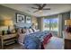 Comfortable bedroom featuring a ceiling fan and large windows with a picturesque view at 780 Meadowbrook Lane, Summerville, SC 29486