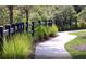Picturesque community walking path lined with a charming fence and lush greenery at 782 Meadowbrook Ln, Summerville, SC 29486