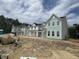 New townhomes with modern farmhouse design feature inviting exteriors with light colors and well-manicured surroundings at 823 Alma Square Dr, Moncks Corner, SC 29461