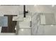Modern farmhouse kitchen materials including white cabinets, dark fixtures, and white marble-look counters create a stylish design at 823 Alma Square Dr, Moncks Corner, SC 29461
