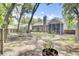 Spacious backyard featuring a screened-in porch, mature trees, and a chimney at 8612 Hickory Creek Ln, North Charleston, SC 29420
