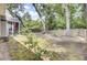 Large backyard area featuring mature trees, fencing and screened in porch at 8612 Hickory Creek Ln, North Charleston, SC 29420