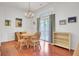 Sunlit dining area with hardwood floors, chandelier, and sliding glass door to the patio at 8612 Hickory Creek Ln, North Charleston, SC 29420