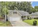 Well-maintained single-story home featuring a two-car garage and landscaped front yard at 8612 Hickory Creek Ln, North Charleston, SC 29420