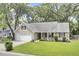 Attractive single-Gathering home with lush green lawn, attached garage, and curb appeal at 8612 Hickory Creek Ln, North Charleston, SC 29420