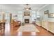 Cozy living room with fireplace, wood floors, large windows, and comfortable seating at 8612 Hickory Creek Ln, North Charleston, SC 29420