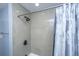 Shower stall with tile walls, dark bronze shower head and faucet with a white shower curtain at 881 Evans Rd, Charleston, SC 29412