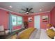 Bedroom with salmon-colored walls, ceiling fan, large window, and a queen bed at 881 Evans Rd, Charleston, SC 29412